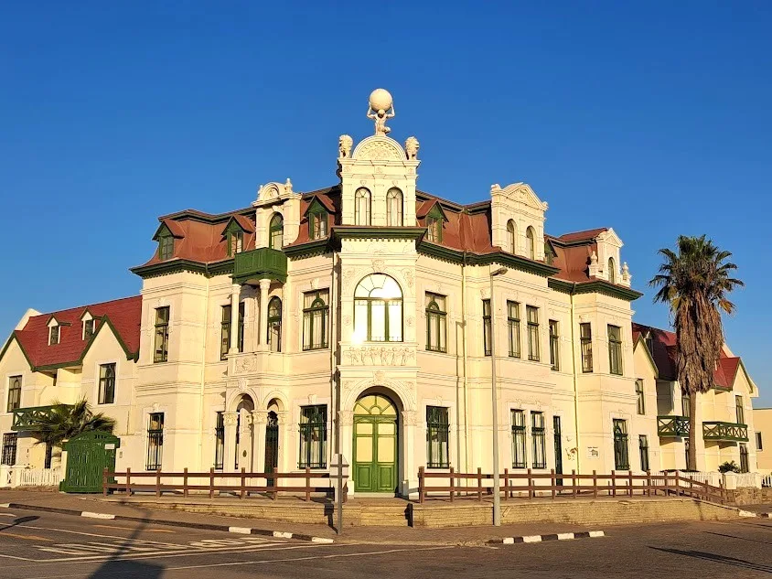 The Hohenzollern Building facade bathed in golden hour light in Swakopmund