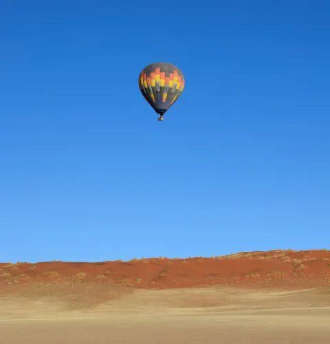 Hot air balloon floating above the Namib Desert