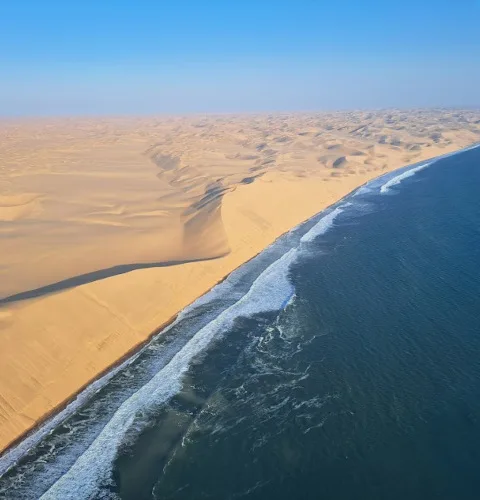 Aerial view of the South Atlantic Ocean meeting the Namib Desert on an unpopulated stretch of coastline