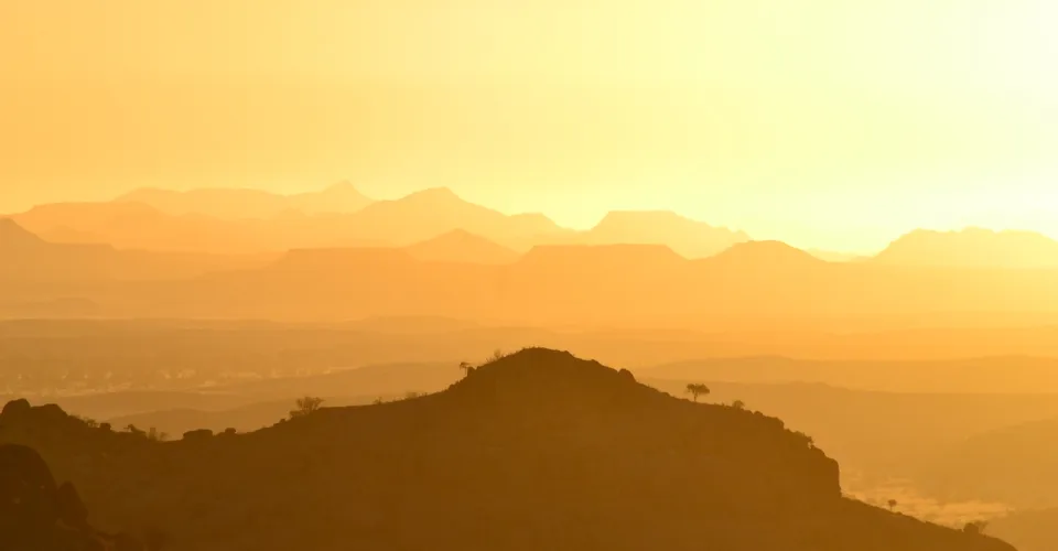 Namibian mountain ranges glowing in warm golden hour light